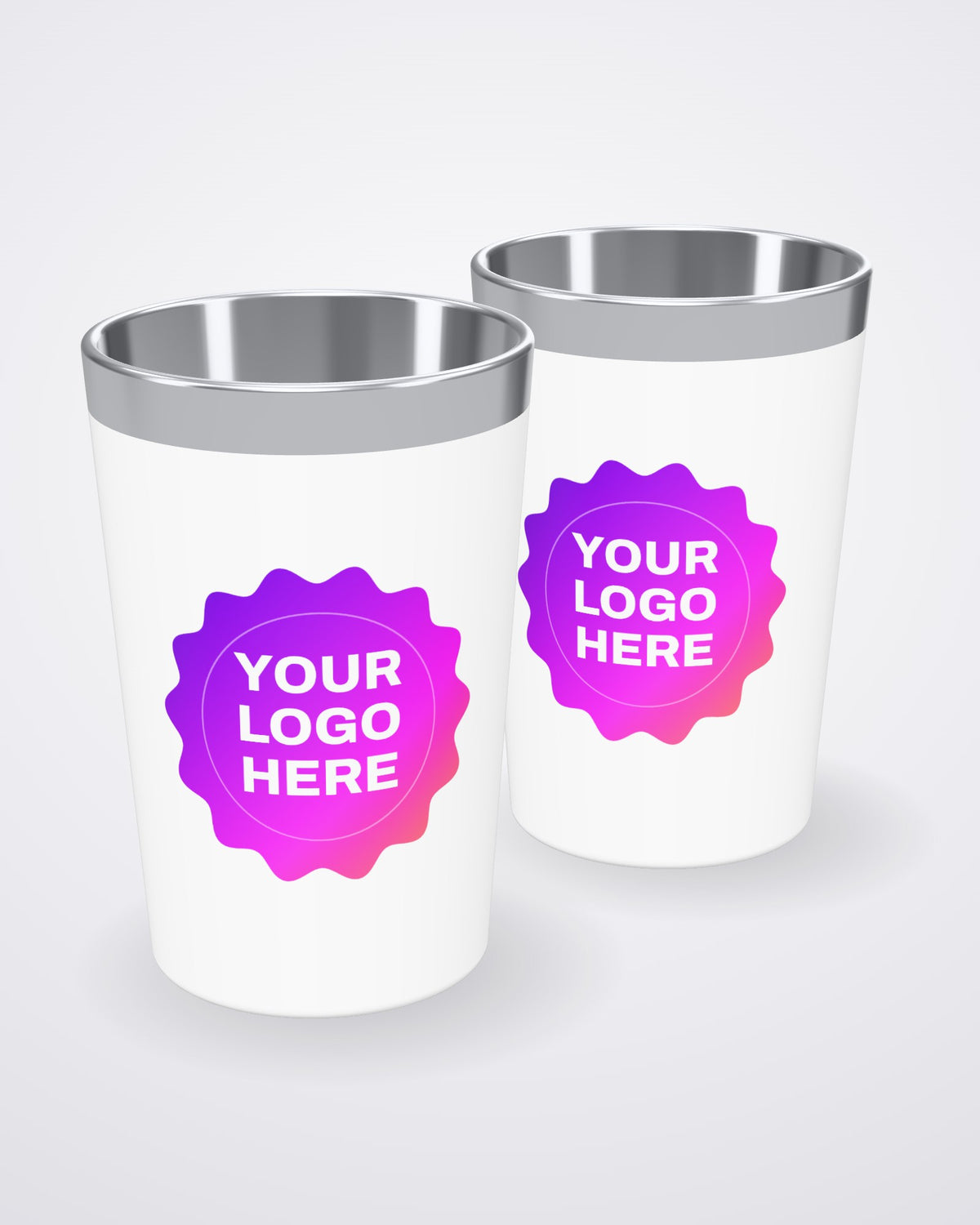 Two custom 12 oz coffee tumblers, white with a stainless steel rim, printed with your logo by iPic Studio (3D mockup)